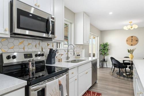 a kitchen with a stove and a microwave at Cozy-Perfect location-Private Pool-Heat Optional-SunsetFun-GCU in Phoenix