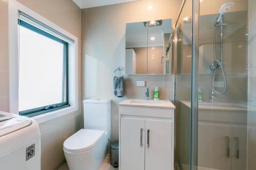 a bathroom with a toilet and a shower and a sink at Ocean Grace by the River and Ocean Pet Friendly in Ocean Grove