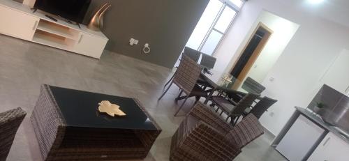 a room with a table and some chairs and a table and a tableablish at Apartments A&A - Santa Maria in Santa Maria