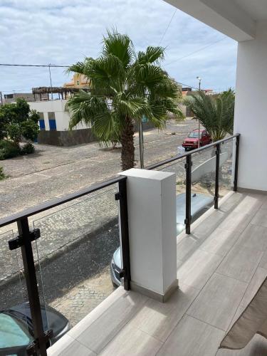 a view of a palm tree from a balcony at Tity Apartments T2- Santa Maria in Santa Maria