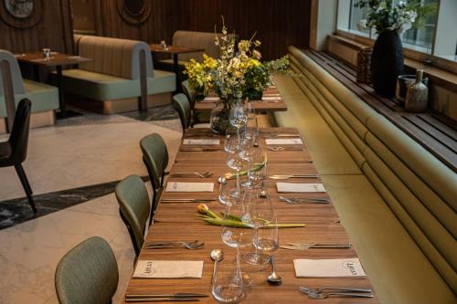 a long table with wine glasses and flowers on it at Crowne Plaza Brussels Airport by IHG in Zaventem