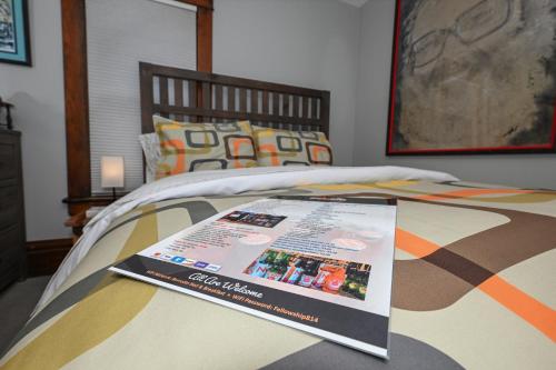 a magazine sitting on top of a bed at Berrodin Bed & Breakfast in Akron