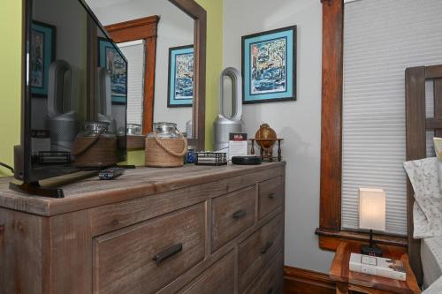 a wooden dresser with a mirror on top of it at Berrodin Bed & Breakfast in Akron