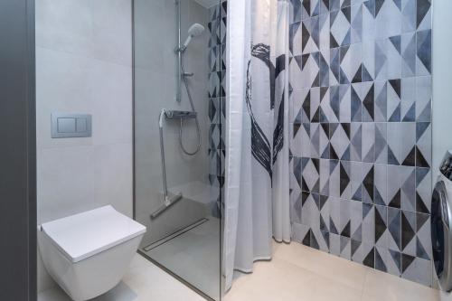a bathroom with a shower and a toilet at Cozy apartment by the Baltic Sea in Tallinn