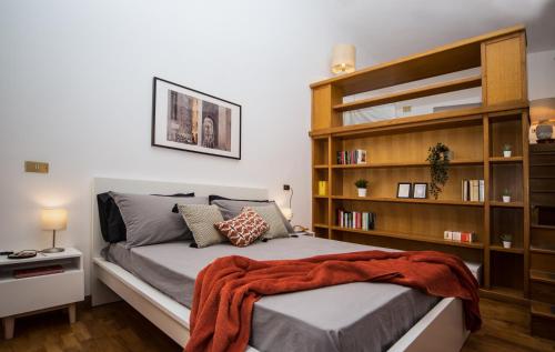 a bedroom with a bed with a book shelf at Casa Frangiò Modern Apartment Historical Centre in Naples