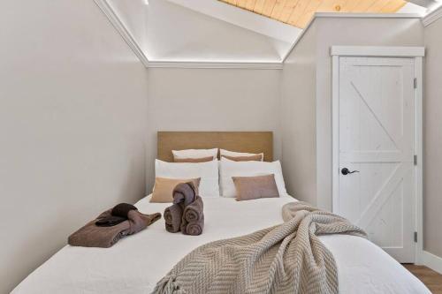 a bedroom with a large white bed with shoes on it at Tahoe Bliss: Ski, Hike, & Relax in Incline Village