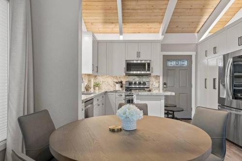 a kitchen with a wooden table with chairs and a dining room at Tahoe Bliss: Ski, Hike, & Relax in Incline Village