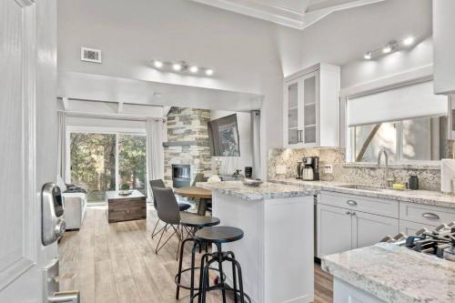 a kitchen with white cabinets and bar stools at Tahoe Bliss: Ski, Hike, & Relax in Incline Village