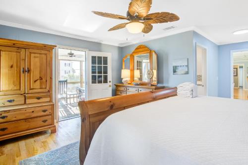 a bedroom with a bed and a ceiling fan at Livin Is Easy in Edisto Island