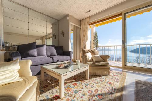 un salon avec un canapé et une table dans l'établissement Le Panoramic - Magnifique Vue sur le lac d'Annecy, à Annecy