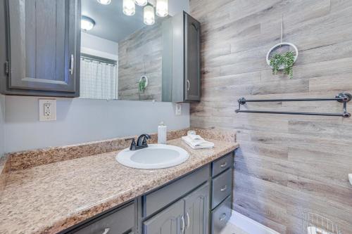 a bathroom with a sink and a mirror at Family-Friendly Boyne Falls Home Golf, Ski and More in Boyne Falls