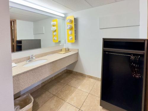 a bathroom with a sink and a mirror at Motel 6-Dyersburg, TN in Dyersburg