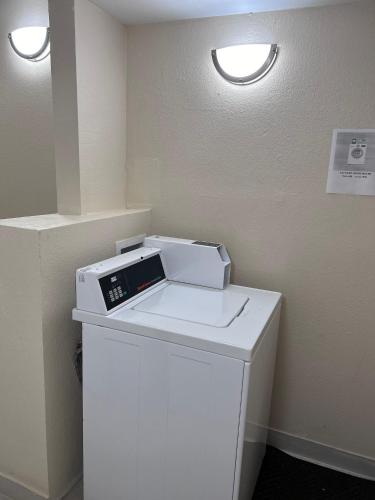 a fax machine sitting on top of a white refrigerator at Red Roof Inn Richmond, IN in Richmond