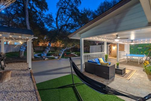 a hammock on a patio of a house at Beautiful Texas Ranch House, Game Room & Minigolf in San Antonio