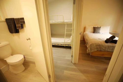 a small room with a bed and a toilet at Mt Warning Rainforest Park 