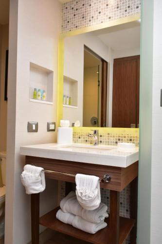 a bathroom with a sink and a mirror at Hampton Inn by Hilton Hermosillo in Hermosillo