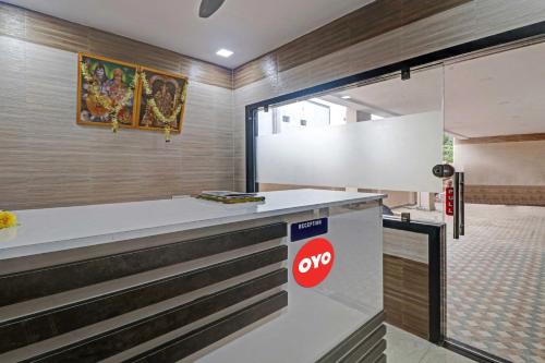 a counter in a room with a sign on it at OYO Flagship 84218 Hotel Bankar House in Sonai