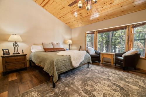 a bedroom with a bed and a chair and a window at Big Bear Family Chateau, Hot Tub, Pool Table, Ev in Big Bear Lake