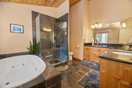 a large bathroom with a tub and a sink at 5 Star Family Cabinhot Tubpool Tableev Charger in Big Bear Lake