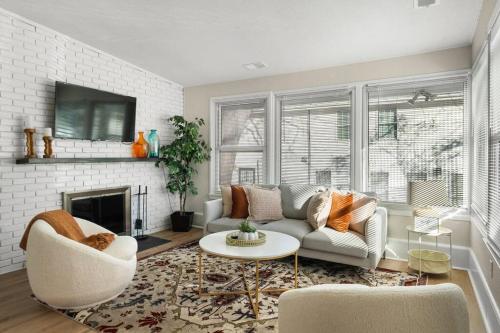 a living room with a couch and a fireplace at FallsChurch, Tysons Corner, Dulles airport, DC in Falls Church