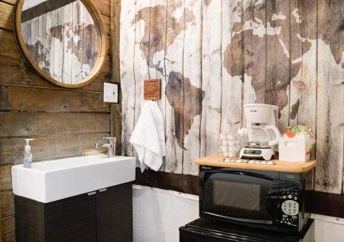 a bathroom with a sink and a microwave and a microwave at The Chadwick in San Diego