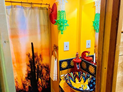 a bathroom with a sink and a shower curtain at The Chadwick in San Diego