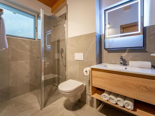 a bathroom with a toilet and a sink and a shower at Mountain Chalet Chapeau in Sankt Lorenzen ob Murau