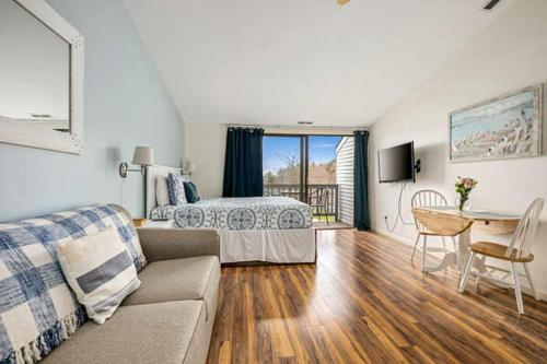 a living room with a couch and a bed and a table at The Shores in Williamsburg