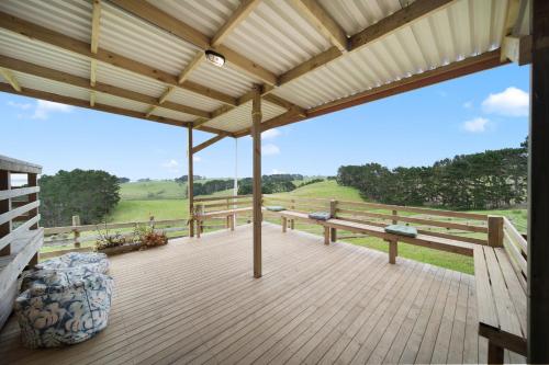 a large wooden deck with a view of the countryside at Apartment 3 in Auckland