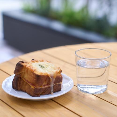 a plate of french toast and a glass of water at FAV LUX Nagasaki in Nagasaki