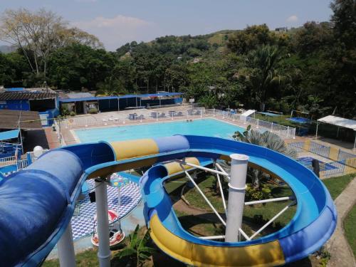 a large swimming pool with a water slide at Hotel Ambeyma in Garzón