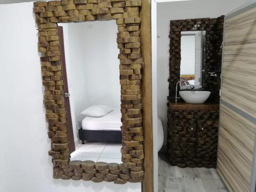 a bathroom with a mirror and a sink at Hotel Ambeyma in Garzón