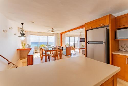 a kitchen and living room with a table and chairs at Amazing Caribbean Ocean view at Villas Marlin in Cancun in Cancún