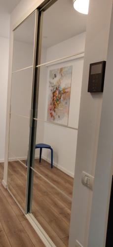 a mirror in a room with a painting on the wall at Modern Apartment with great terasse and mountain view in Braşov