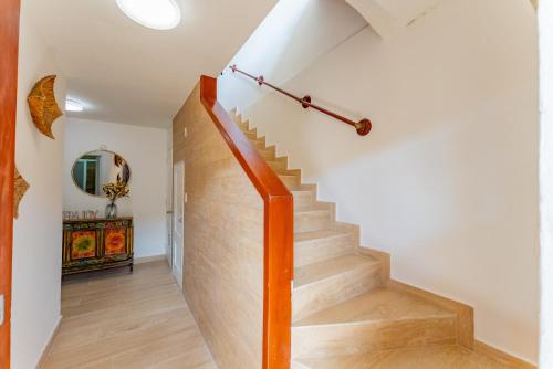 a staircase in a home with white walls and wooden floors at Amazing Caribbean Ocean view at Villas Marlin in Cancun in Cancún