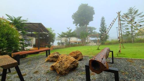 a park with benches and rocks and a playground at Heaven Hill Camping in Ban Thung Na