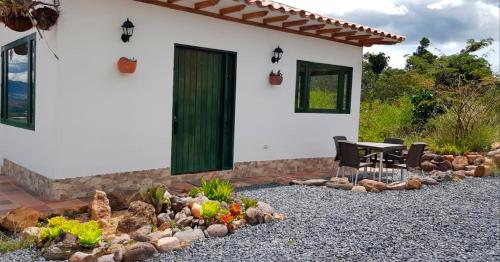 a patio with a table and chairs in front of a house at El Garabandal in Villa de Leyva
