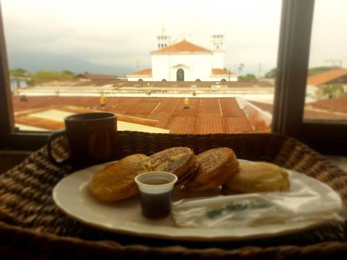 a plate of food with pastries on a table at El Mirador in Juayúa
