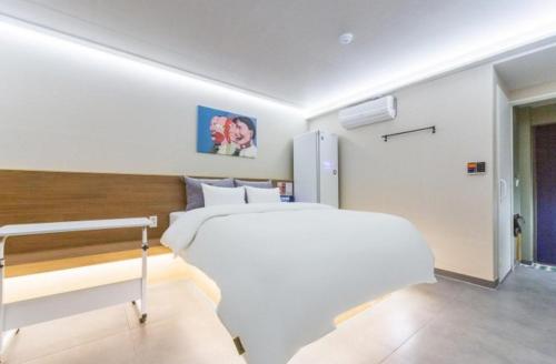 a bedroom with a white bed in a room at Hotel The Araboda in Gwangju