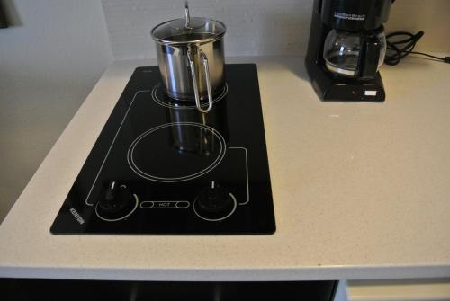 a stove top with a coffee pot on a counter at Candlewood Suites Sterling by IHG in Sterling