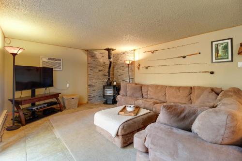 a living room with a couch and a flat screen tv at The Sisters Moose in Sisters