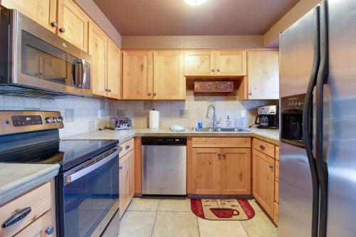 a kitchen with wooden cabinets and stainless steel appliances at The Sisters Moose in Sisters
