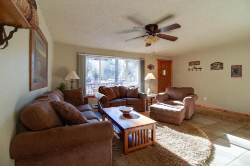 a living room with couches and a ceiling fan at The Sisters Moose in Sisters
