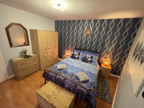 a small bedroom with a bed and a mirror at Beanies LorneStreet Four Bed House in Swindon