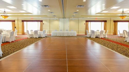 a large room with white chairs and tables in a room at Holiday Inn & Suites Clearwater Beach by IHG in Clearwater Beach