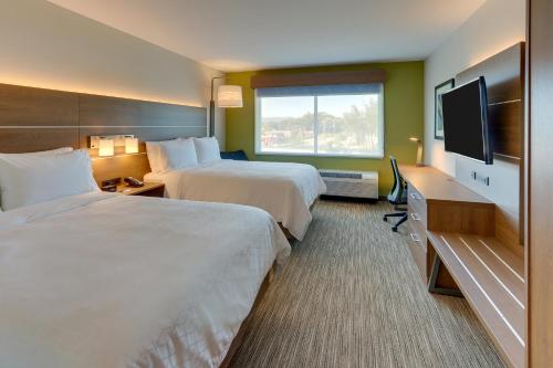 a hotel room with two beds and a flat screen tv at Holiday Inn Express & Suites - Roanoke – Civic Center in Roanoke