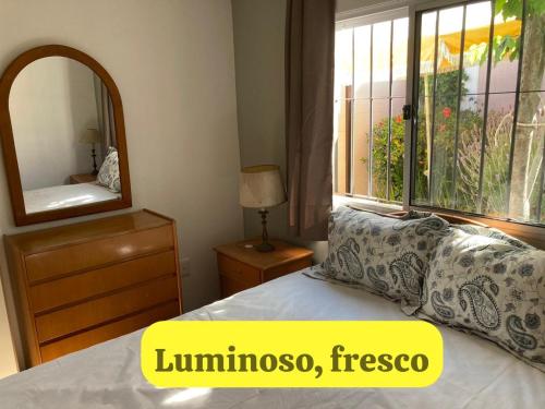 a bedroom with a bed and a mirror and a window at Mar 11 a 100 mtros del mar in Parque del Plata