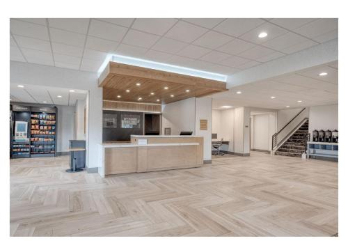 an empty lobby with a counter in a store at Holiday Inn Express Federal Way - Seattle South by IHG in Federal Way