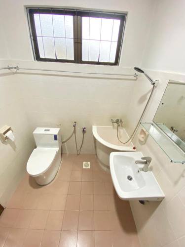 a bathroom with a white toilet and a sink at Ipoh Center Elegant Bungalow Near to Sunway in Ipoh
