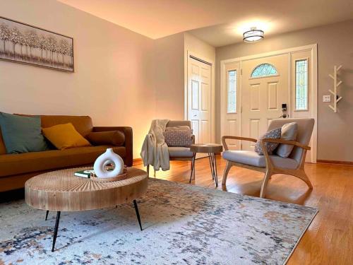 a living room with a couch and chairs and a table at Cozy 3 bdr Retreat in a Prime location in Streamwood